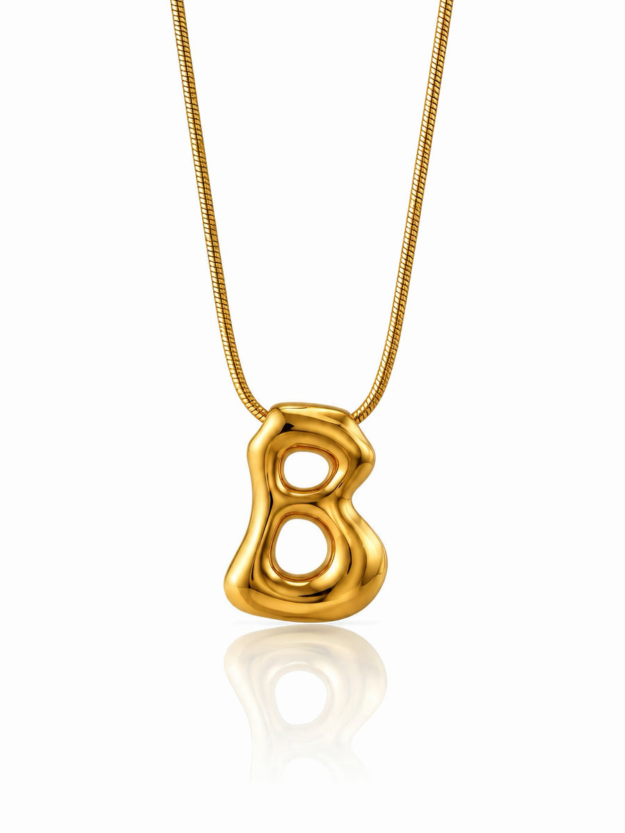 Collana Boubble con lettere di GLAMORIZE STUDIO, dettagliata con pendenti a forma di lettere, in metallo dorato.